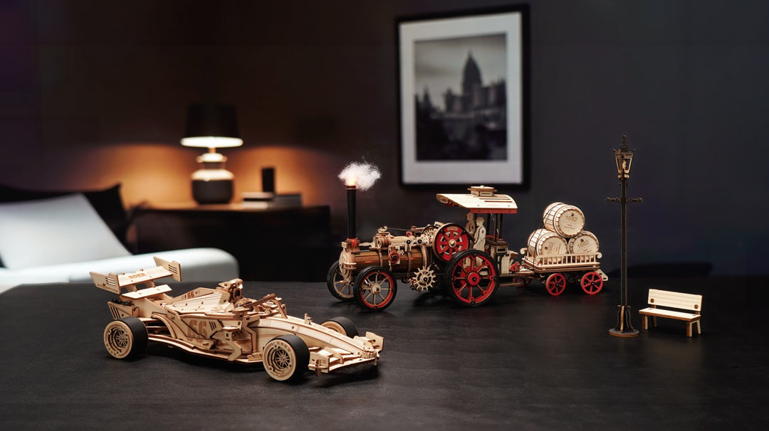 ROKR Racing Car and Steam Engine wooden car models on desktop